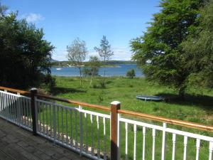 a balcony with a view of a lake at Beachcombers in Craobh Haven