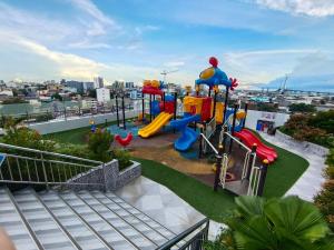 a view of a playground with a slide at Arc tower- Sweet Stay Cebu in Cebu City