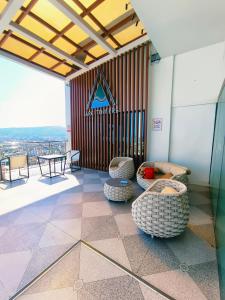 a room with two chairs and a table in a building at Arc tower- Sweet Stay Cebu in Cebu City