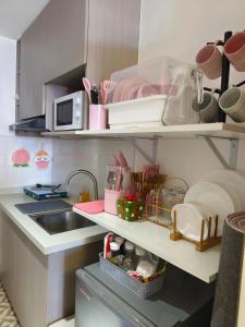 a kitchen with a sink and a counter top at Arc tower- Sweet Stay Cebu in Cebu City