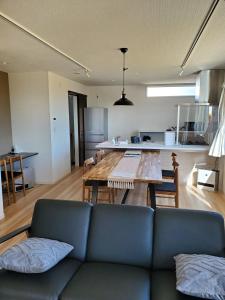 a living room with a blue couch and a table at 鉾田の家 in Hokota