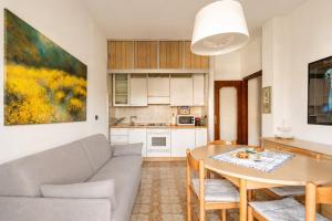 a living room with a couch and a table at oasi corallo in Diano Marina