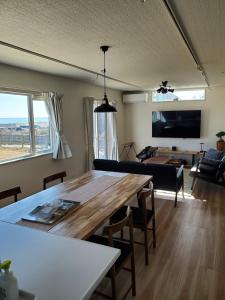 a living room with a table and a couch at 鉾田の家 in Hokota
