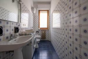 a bathroom with a sink and a toilet at oasi corallo in Diano Marina +6 photos