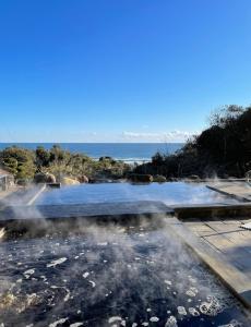 a hot spring with steam coming out of it at 鉾田の家 in Hokota