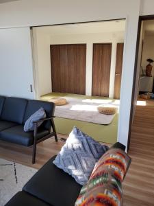 a living room with a couch and a mirror at 鉾田の家 in Hokota +53 photos