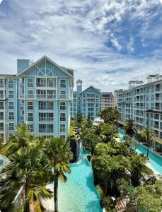 an aerial view of a resort with palm trees at Pattaya Private Beach - Grand Florida Beachfront Condo Resort in Na Jomtien