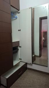 a room with white cabinets and a mirror at Rego Farms in Mangalore +12 photos