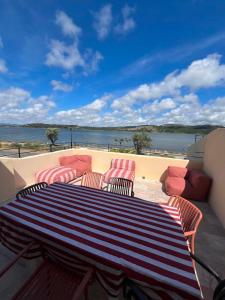 a table and chairs on a balcony with a view of the water at Les clés de Jules in Gruissan