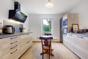 a kitchen with a small table in the middle at Gite de l'Egal in Le Buisson de Cadouin