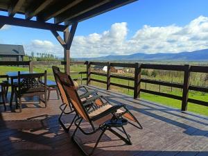 a deck with a bench and a table and a view at Domek w górach Łubinowa 6 in Międzylesie