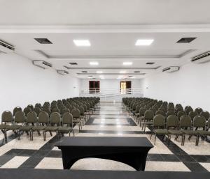 an empty room with chairs and tables in it at Villa Nautilus Be Happy in Fortaleza +84 photos