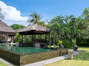 a swimming pool with a gazebo next to a house at Villa Bossi Bali at Tanguwesia in Bubunan