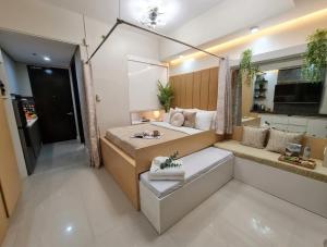 a large room with a bed and a bathroom at Midtown Cebu City Condo in Cebu City