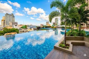 a swimming pool with a city skyline in the background at Midtown Cebu City Condo in Cebu City