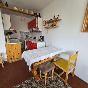 a kitchen with a table and a chair in it at Kwatera bez cioci in Gdańsk