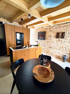 a kitchen with a table with a wooden bowl on it at Casa Eddy in Bale