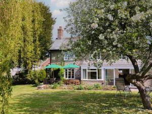 a house with a table and chairs in the yard at Harbins Farm in Sherborne