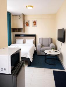 a hotel room with a bed and a tv at AceStudio Kikuyu with Parking and Lift in Kikuyu