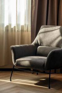 a chair sitting in front of a window at Bastion Hotel Dordrecht Papendrecht in Dordrecht