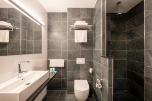 a bathroom with a toilet and a sink at Bastion Hotel Dordrecht Papendrecht in Dordrecht