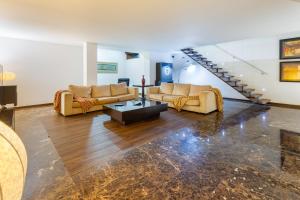 a living room with two couches and a table at Luxury by ON Apartments in Porto
