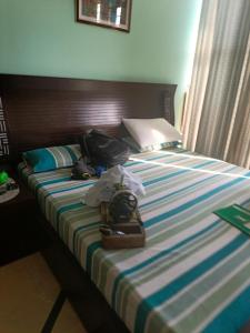 a bed with shoes and luggage sitting on it at Studio 430 in Islamabad