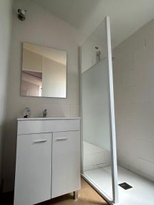 a white bathroom with a sink and a mirror at Casita la Loma in Cádiz +4 photos