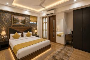 a hotel room with a bed and a desk and a bedroom at Hotel La Casa Near Delhi Airport in New Delhi