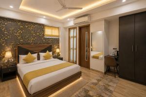 a hotel room with a bed and a desk and a bedroom at Hotel La Casa Near Delhi Airport in New Delhi +29 photos