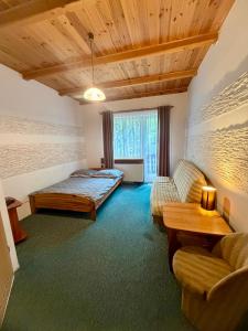 a room with a bed and a couch and a table at Zimorodek smart tv NETFLIX pokoje SUPERIOR z balkonami Las Szlaki Aquapark in Karpacz