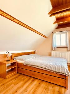 a bedroom with a bed and a desk and a window at Ubytování u Chladů in Horská Kvilda +46 photos