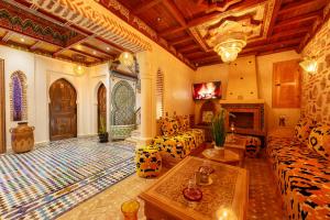 a living room with a couch and a fireplace at Riad Sultan Chefchaouen in Chefchaouen