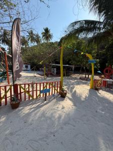 a playground on the beach with flags and swings at Redang Campstay in Redang Island