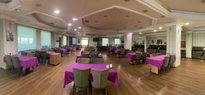 a banquet hall with purple tables and chairs at Grand Ali'n Tokat in Tokat