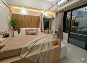 a bedroom with a large bed and a large window at Midtown Cebu City Condo in Cebu City +32 photos