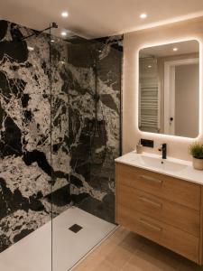 a bathroom with a sink and a glass shower at Residencial Lleida in Lleida +4 photos