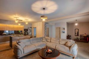a living room with a couch and a table at Old Square House in Pefkochori