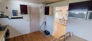 a kitchen with a vacuum in the corner of a room at M1 Stay in Bevtoft