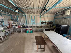 a large kitchen with a table in a room at Redang Campstay in Redang Island