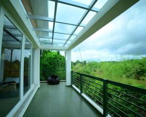 a room with a balcony with a view at Assraya stay in Kushālnagar