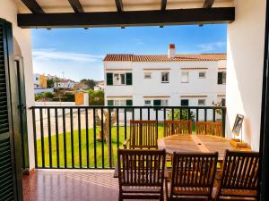 a patio with a table and chairs on a balcony at Cala Porter Brise Marine in Cala en Porter +50 photos