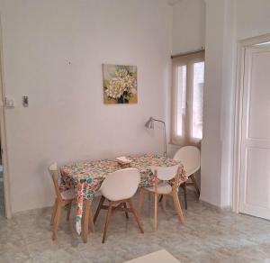 a dining room with a table and four chairs at Marvelous flat in the city center in Ceuta