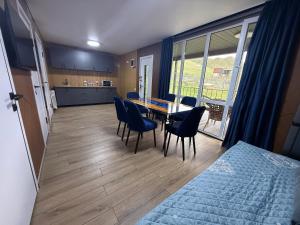 a room with a table and chairs and a kitchen at Opensky-kolsay 2 in Saty