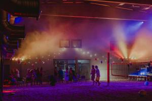 a group of people on a stage with lights at KVARC Hotel in Valmiermuiža