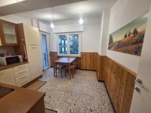 a kitchen with a table and a dining room at Mamma Lucia accommodation in Borno