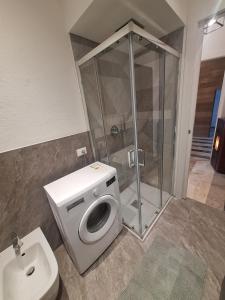 a bathroom with a shower and a toilet and a sink at Mamma Lucia accommodation in Borno +5 photos