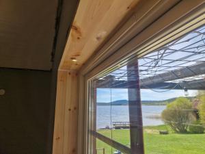 a window in a room with a view of a lake at Sjöstugan in Leksand +5 photos