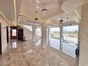 a large room with a lobby with a table at Avera luxurious stay in Igatpuri