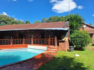 a swimming pool in the yard of a house at SMAPERS GUESTHOUSE in Brits